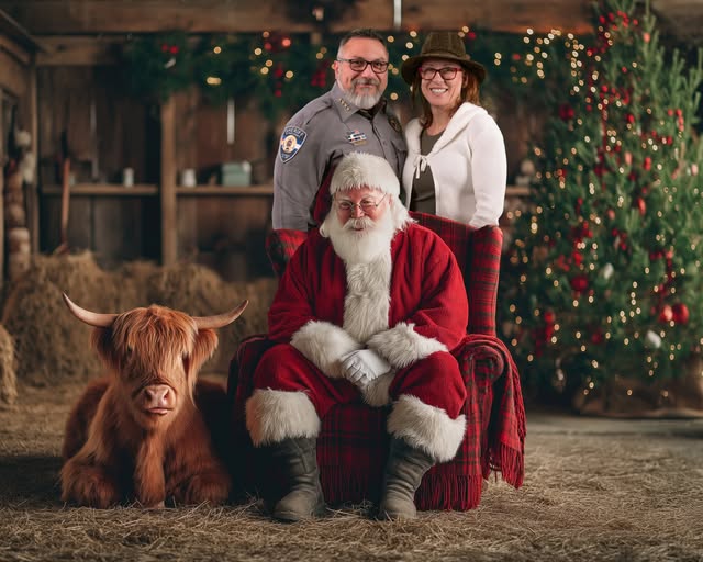 Sheriff Roybal, Melissa Roybal, and Santa Claus with a highland baby cow.